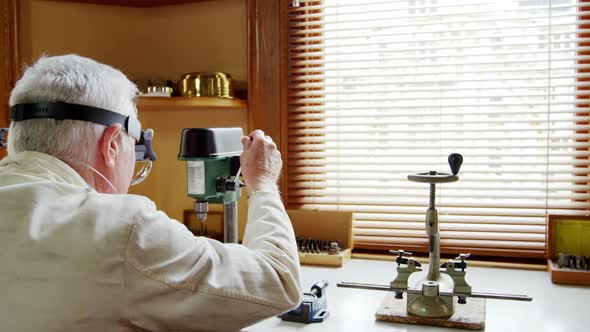 Horologist repairing a watch