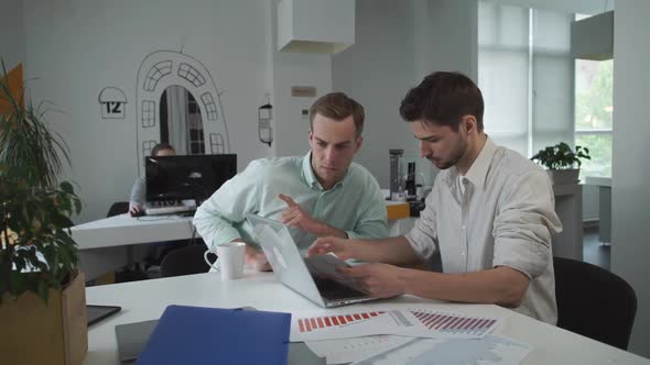 Head of Marketing Department Checking Report with Data at the Computer