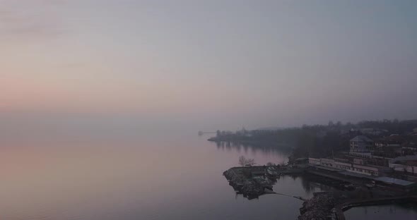 Flying Along The Coast Of A Small Town At Sunset