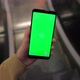 POV Female Hand Holding Smartphone Green Screen in a Mall Escalator - VideoHive Item for Sale