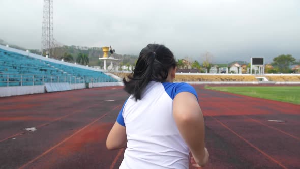 Back View Of Little Girl Running At Stadium alt