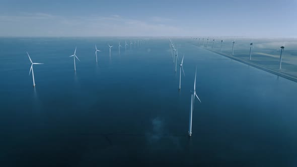 Offshore Windmill Park with Clouds and a Blue Sky Windmill Park in the Ocean Drone Aerial View with