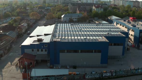 Aerial Drone View. Warehouse with Solar Panelsthe, Sunny Batteries for Receiving Alternative Energy