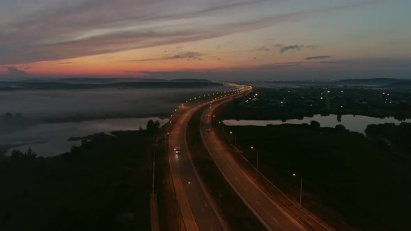 Aerial view of Cars drive on the night highway 09