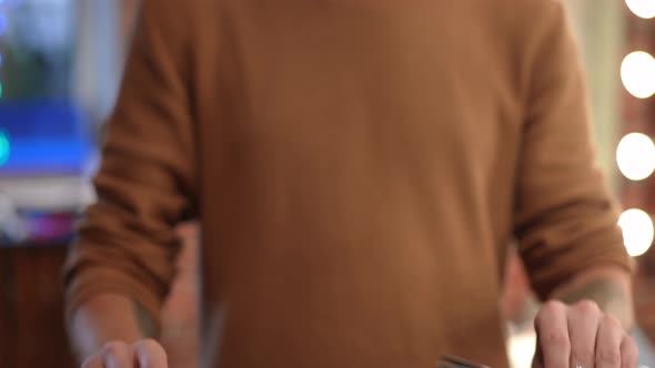 Front View Blurred Hairdresser Raising Hands with Scissors in Slow Motion Standing Indoors