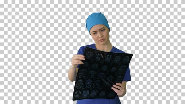 Female doctor looking at brain tomography, Alpha Channel