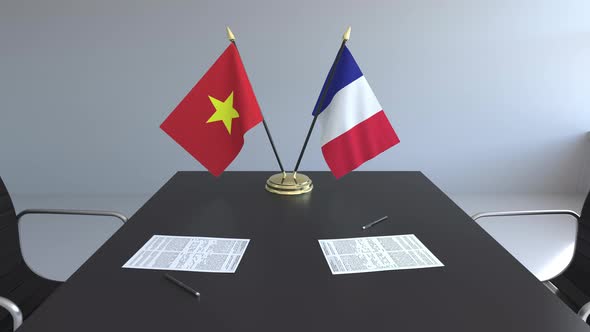 Flags of Vietnam and France on the Table alt