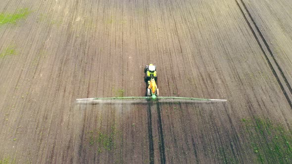 Aerial View Farm Machinery Spraying Insecticide To the Green Field, Agricultural Natural Seasonal