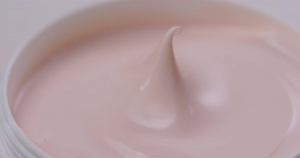 Pink Cosmetics cream with rotate