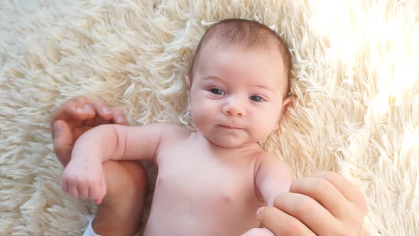 Happy Newborn Baby in White Bed.