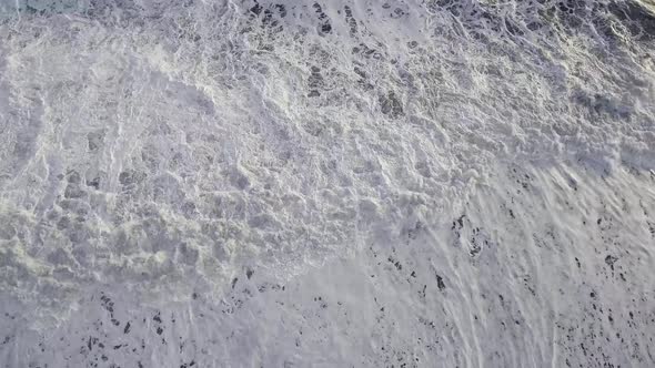 Top down view of majestic waves at Vik black sand beach