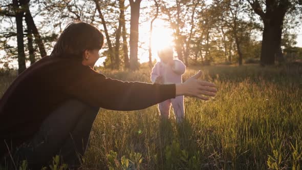 A Small Child Run to His Father in a Hug