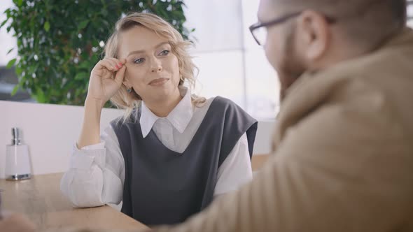 A Married Couple at the Manager's Desk Waiting for a Deal