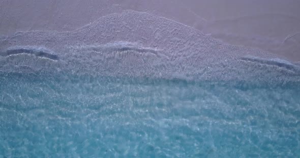 Wide above abstract shot of a white paradise beach and aqua turquoise water background in vibrant 4K