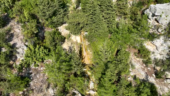 A small waterfall in the mountains aerial view 4 K