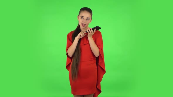 Pretty Young Woman Is Asking for Information on the Network Via Phone. Green Screen