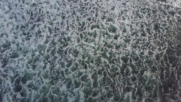 Aerial drone view of the beach, waves and surf in Indonesia.