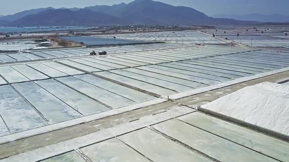 Vehicle Drives Among Salt Plantations Against Hills