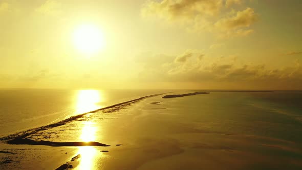 Wide angle overhead copy space shot of a white sand paradise beach and blue water background in colo