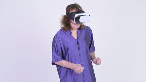 Happy Senior Man Using Virtual Reality Headset