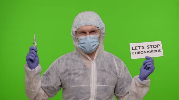 Doctor in PPE Suit with Syringe Ampoule and Text Slogan on Paper Lets Stop Coronavirus Chroma Key