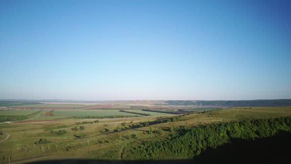 Aerial Video of the Countryside at Sunset on a Sunny Summer Warm Day. Morning or Evening