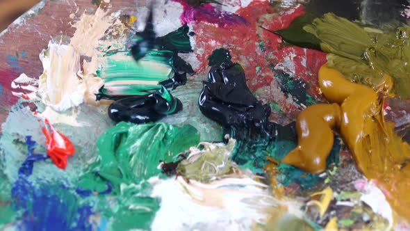 Multicolored Oil Paints on a Palette Mix Spatula. Closeup Details