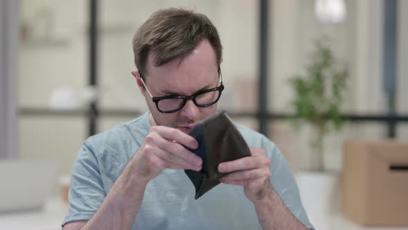 Young Man Checking Empty Wallet Work