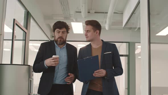 Two Caucasian Businessmen Going along Office