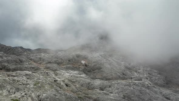 Drone Flight Over Rocky Landscape Under Mist