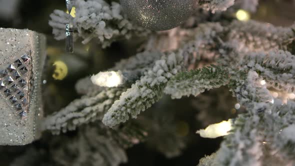 Panning view of white christmas tree covered in decorations