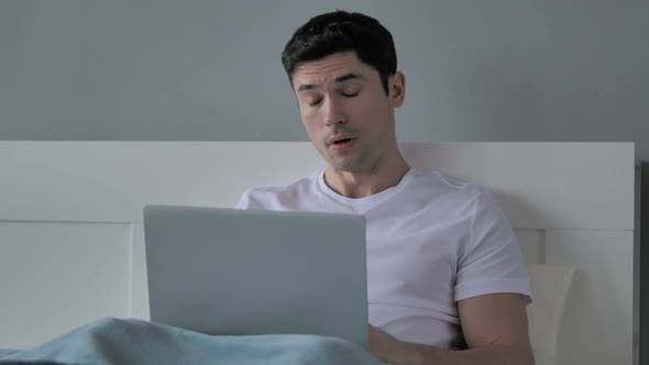 Young Man Sleeping While Using Laptop in Bed