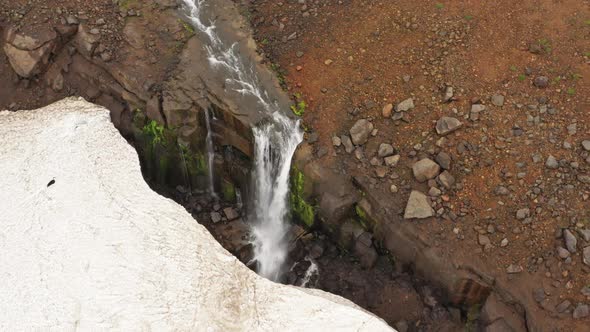 Waterfall and Snow in Mountains