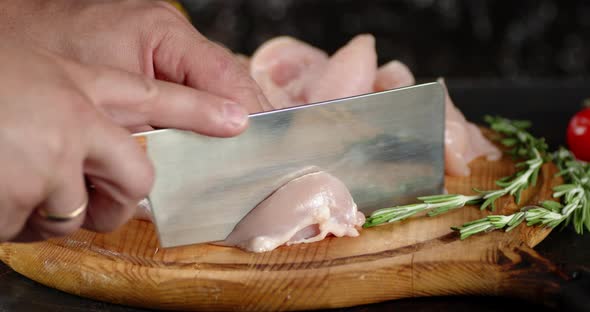 On a Cutting Board Cut Raw Chicken Fillet Into Pieces.