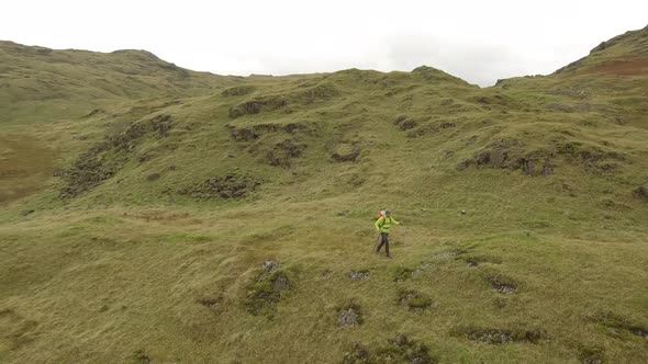 Hiker aerial view hiking in the hills