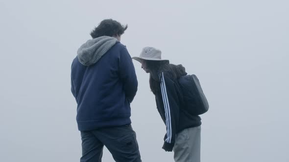 Couples of Asian tourists enjoy taking photos on top of the mountain.