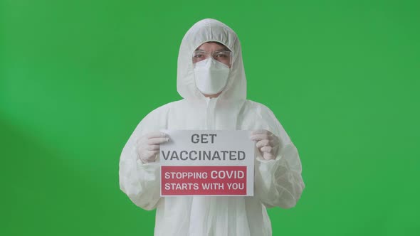 Asian Man Wear Protective Uniform PPE And Holding Get Vaccinated Stopping Covid Starts With You Sign