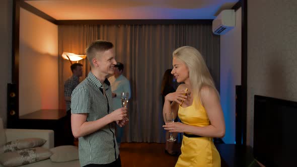 Young Couple Have Private Conversation at Apartment Birthday Party