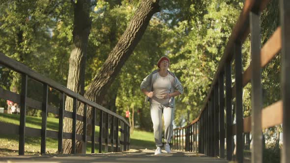 Middle Aged Woman Suddenly Feeling Cramp in Her Leg While Running, Health