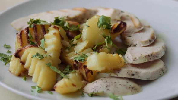 Chicken Meat With Fried Potatoes On A Plate