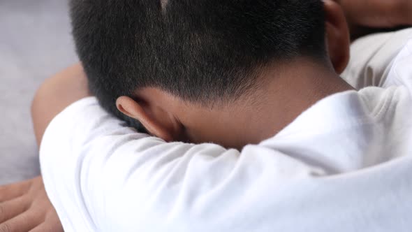 Teenage Boy Head Down on Desk