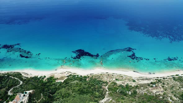 Drone view of scenic beach with white sand and turquoise sea, Greek islands.