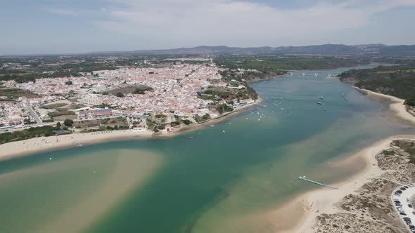 Aerial arc above Vila Nova de Milfontes estuary; famous summer destination