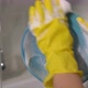Young Woman in Yellow Rubber Gloves in the Kitchen is Washing Dishes By Hand - VideoHive Item for Sale