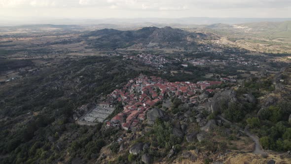 Medieval Monsanto village perched on mountainside overlooking countryside; drone