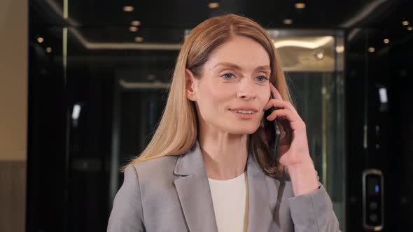 Closeup Face Woman Positive Business Lady Talking on Smartphone in Hallway