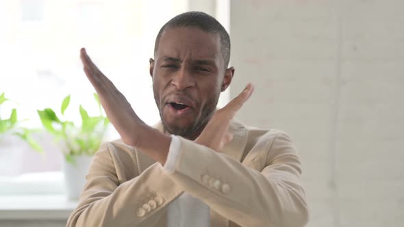 Portrait of African Man Showing No Sign By Arm Gesture Denial