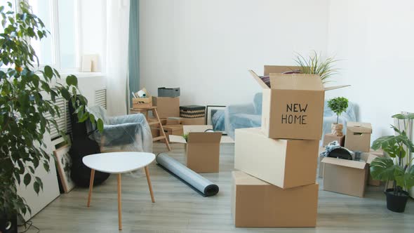 Beautiful New House with Belongings Packed in Cardboard Boxes on Floor