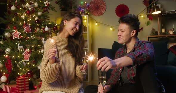 Young Couple Celebrating New Year at Home