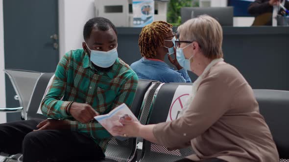 African American Patient Talking to Senior Woman with Face Masks